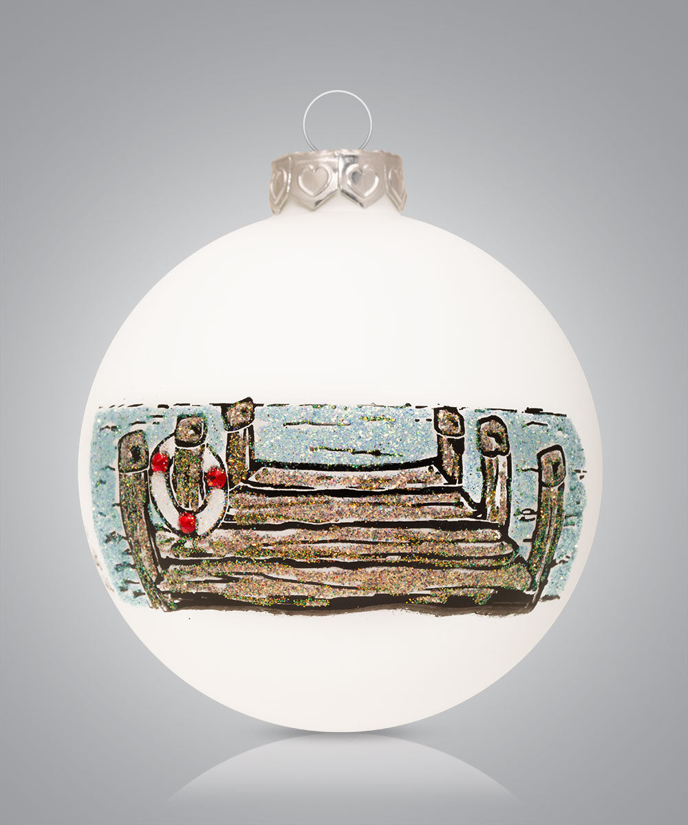 Hand-painted glass ornament depicting a wooden dock on a serene lake