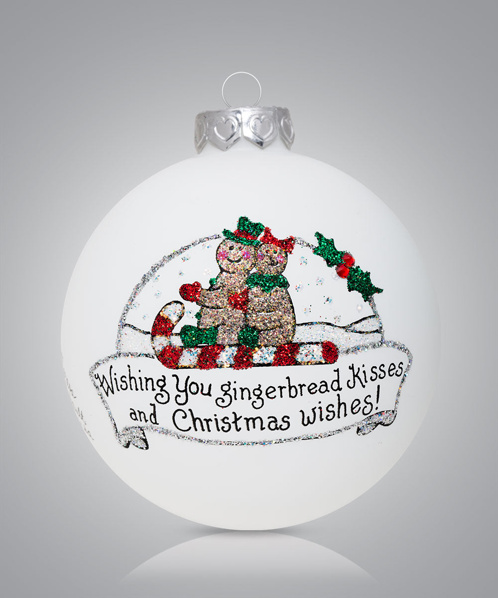 Hand-painted glass ornament with gingerbread cookie in snow globe and festive message