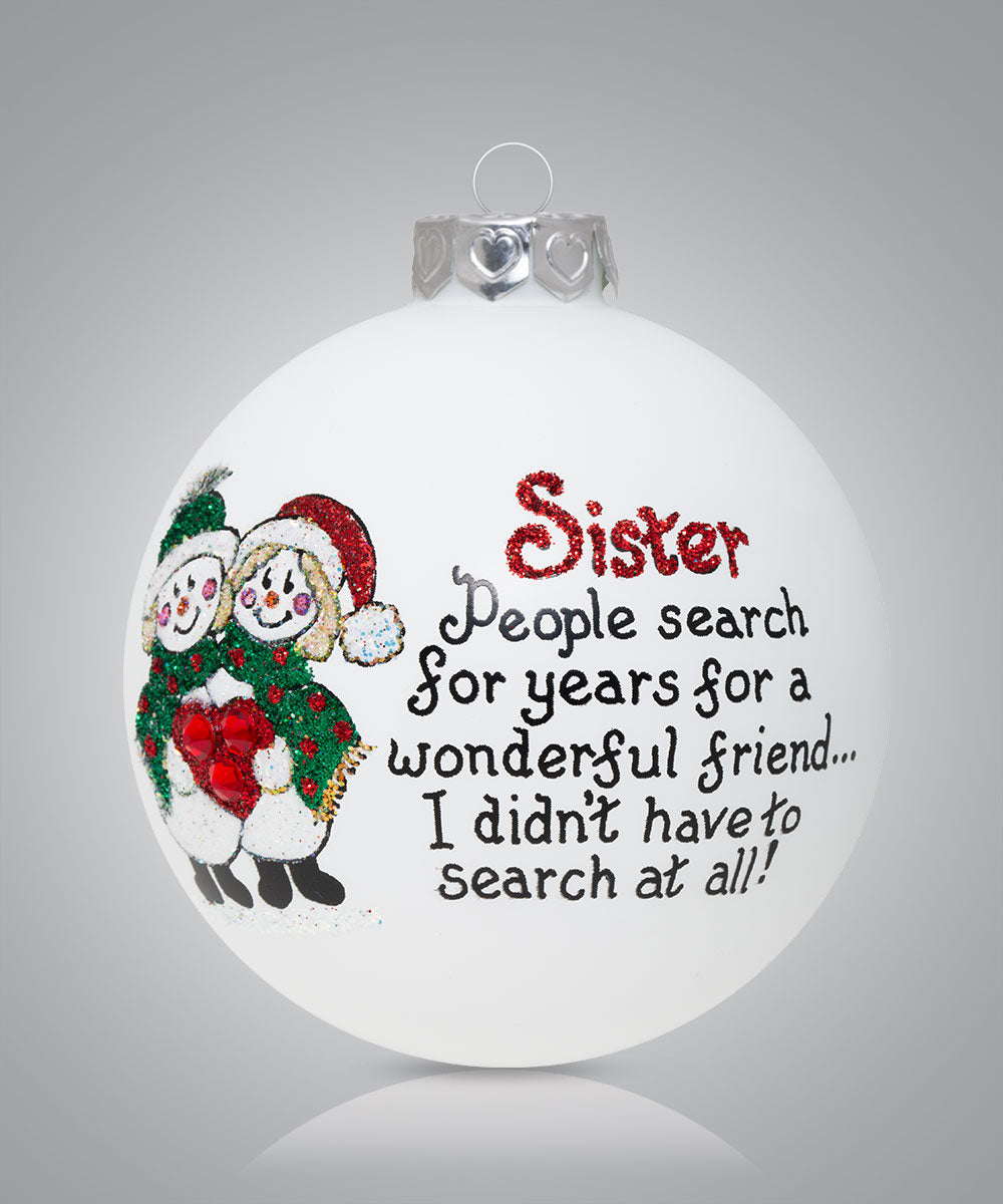 Hand-painted glass ornament with snowmen hugging and message about sisters being wonderful friends