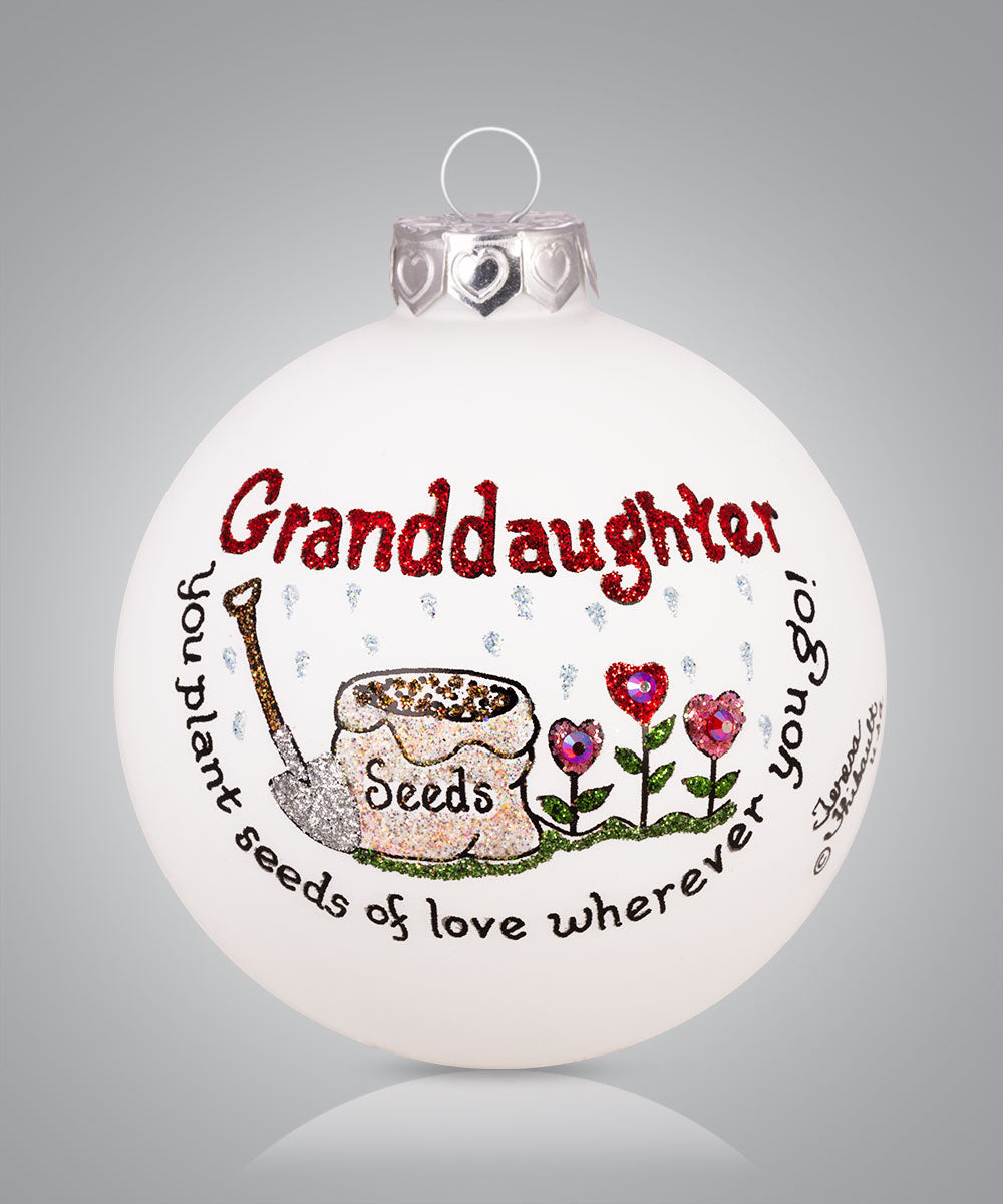 Hand-painted glass ornament with flowers and message about granddaughter planting seeds of love