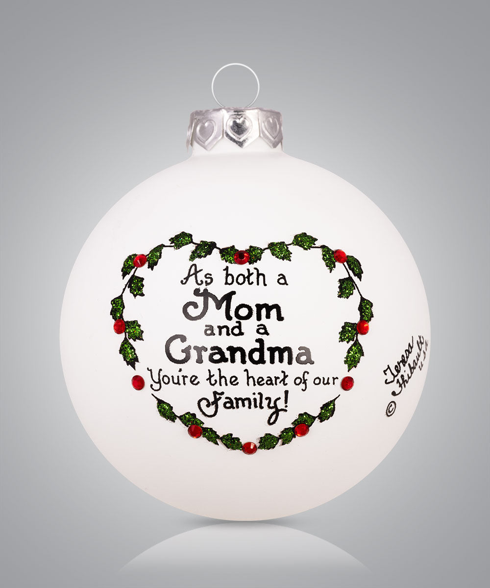 Hand-painted glass ornament with holly heart and message for Mom and Grandma: “You’re the heart of our family”