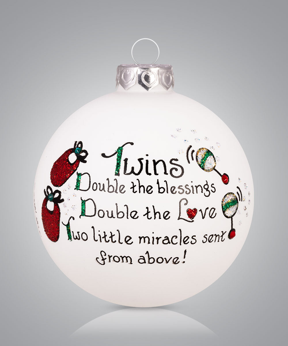 Hand-painted glass ornament for parents of twins with baby items and the phrase “Double the blessings, double the love”