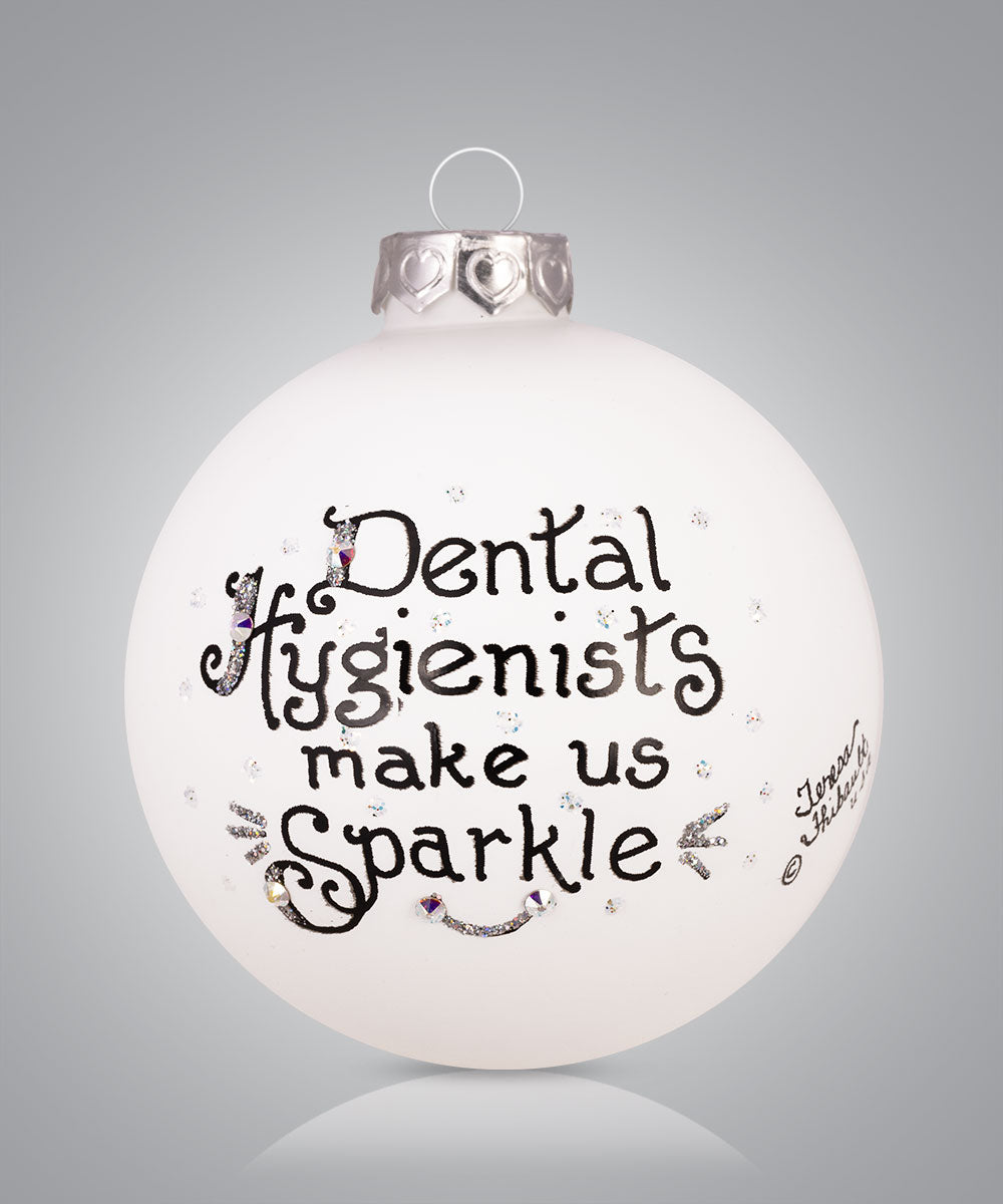 Hand-painted glass ornament with toothbrush sparkle design and message for dental hygienists