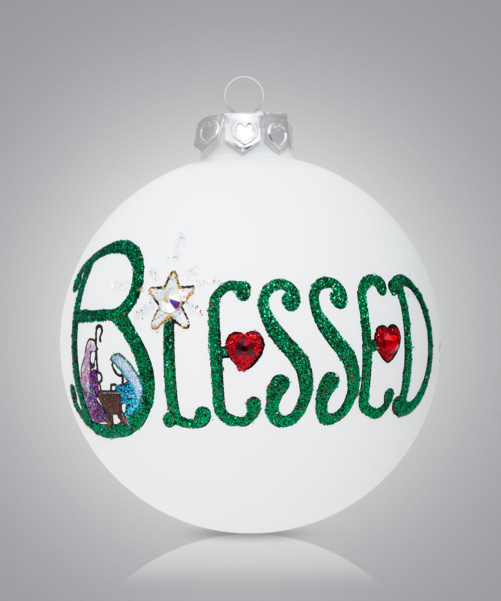 Hand-painted glass ornament with the word Blessed and nativity scene inside the B
