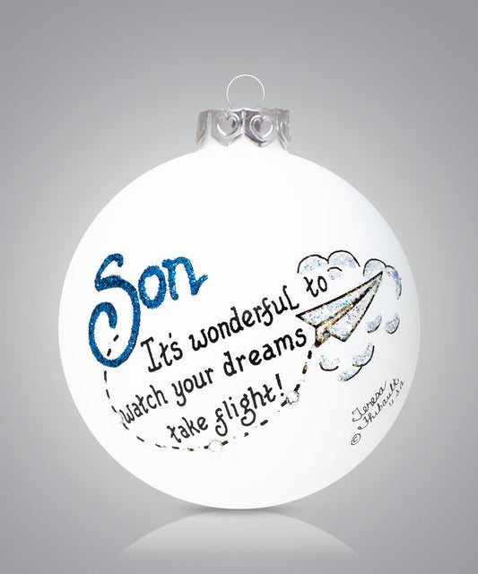 Hand-painted glass ornament with paper airplane and message about son’s dreams taking flight