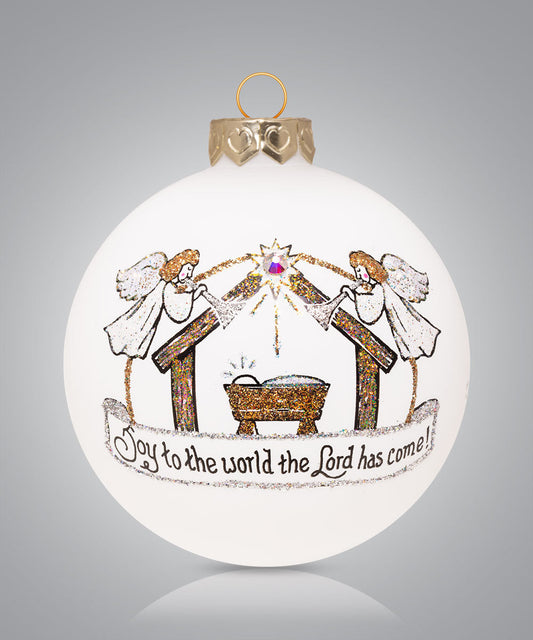 Hand-painted glass nativity ornament with angels and manger and phrase “Joy to the world the Lord has come”