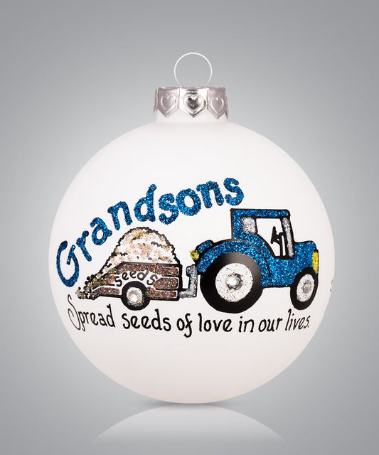 Hand-painted glass ornament with tractor carrying seeds and message about grandsons spreading love