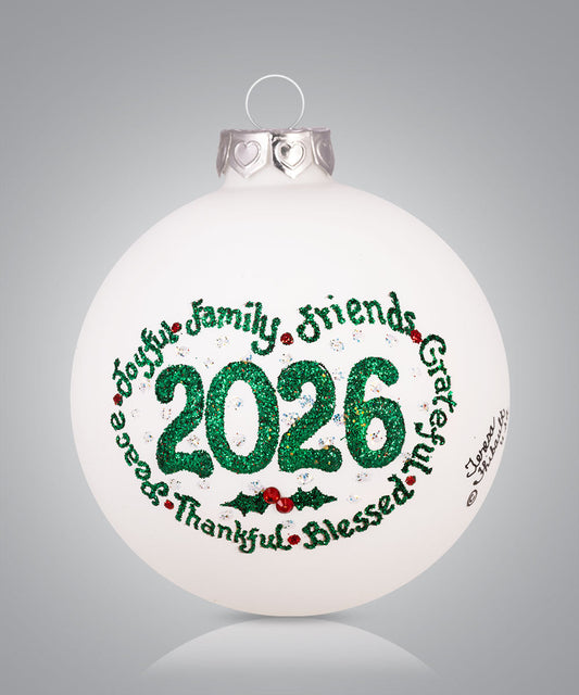 Hand-painted glass ornament featuring 2026 with words like peace, joy, family and friends
