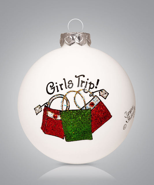 Hand-painted glass ornament with colorful purses and words “Girls Trip”